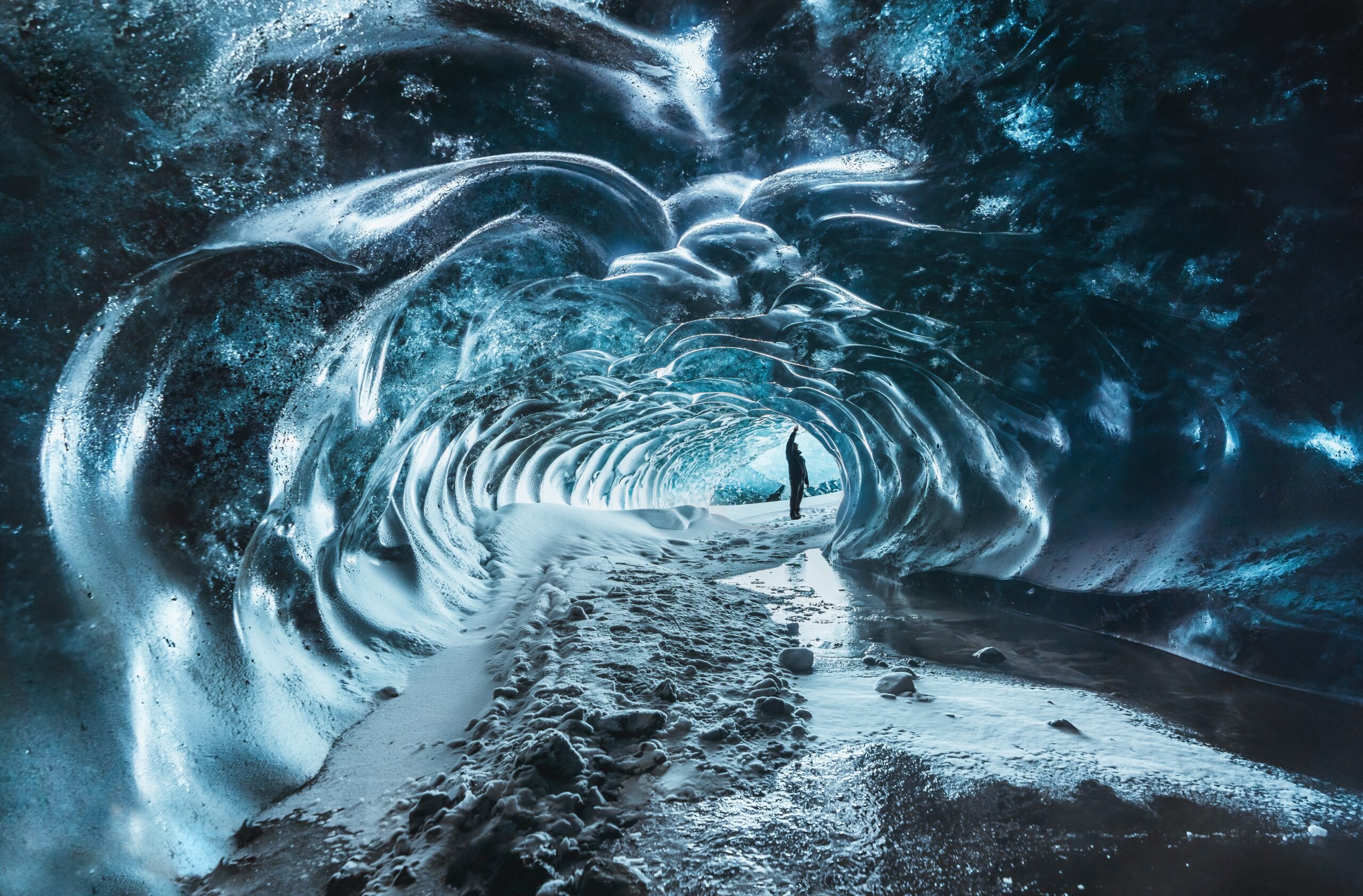Blue,Crystal,Ice,Cave,Entrance,With,Tourist,Climber,And,An